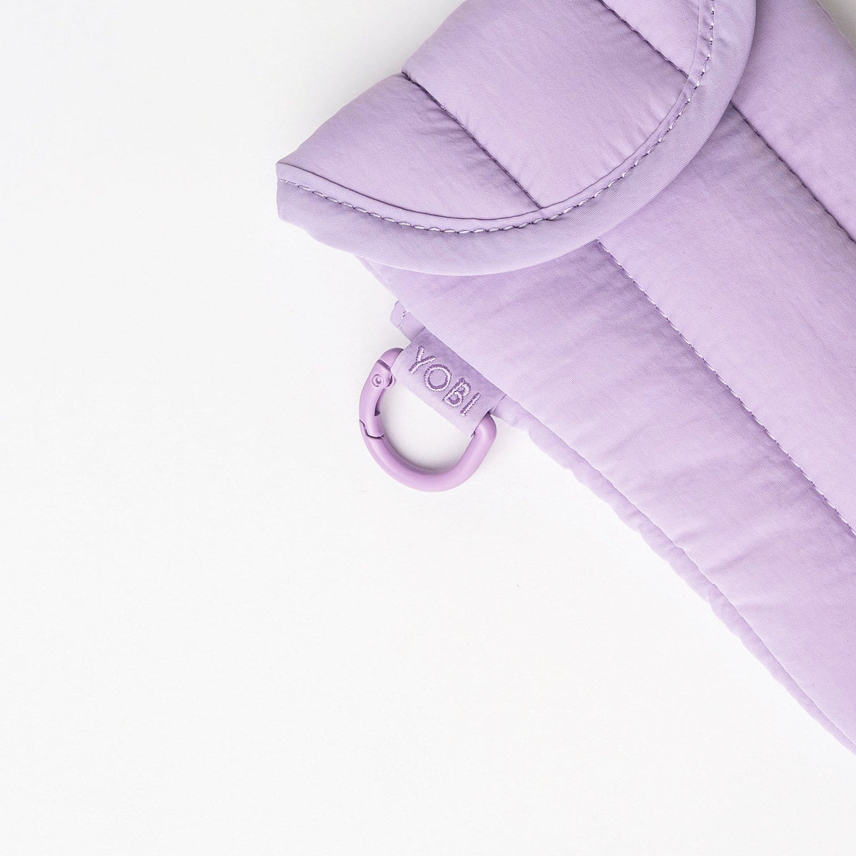 A light purple quilted pouch with a matching loop strap, photographed on a clean white background.