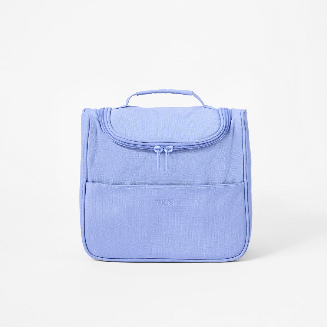 Blue Toiletry Bag showing front zip pocket and top handle