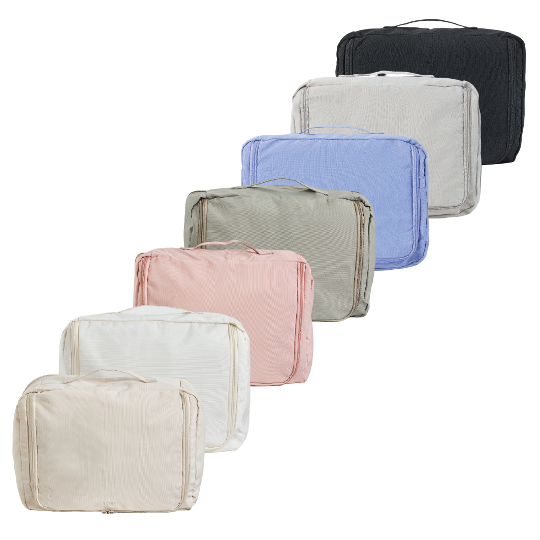 Set of variously colored packing cubes on a white background