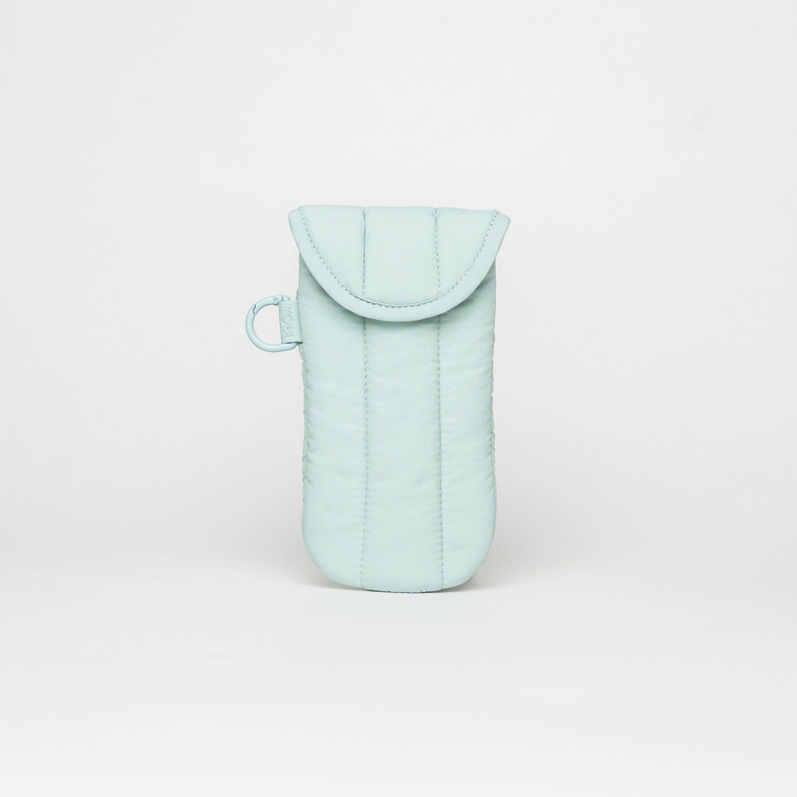 A light mint green quilted phone pouch with a flap closure and a small matching loop, centered on a clean white studio background.