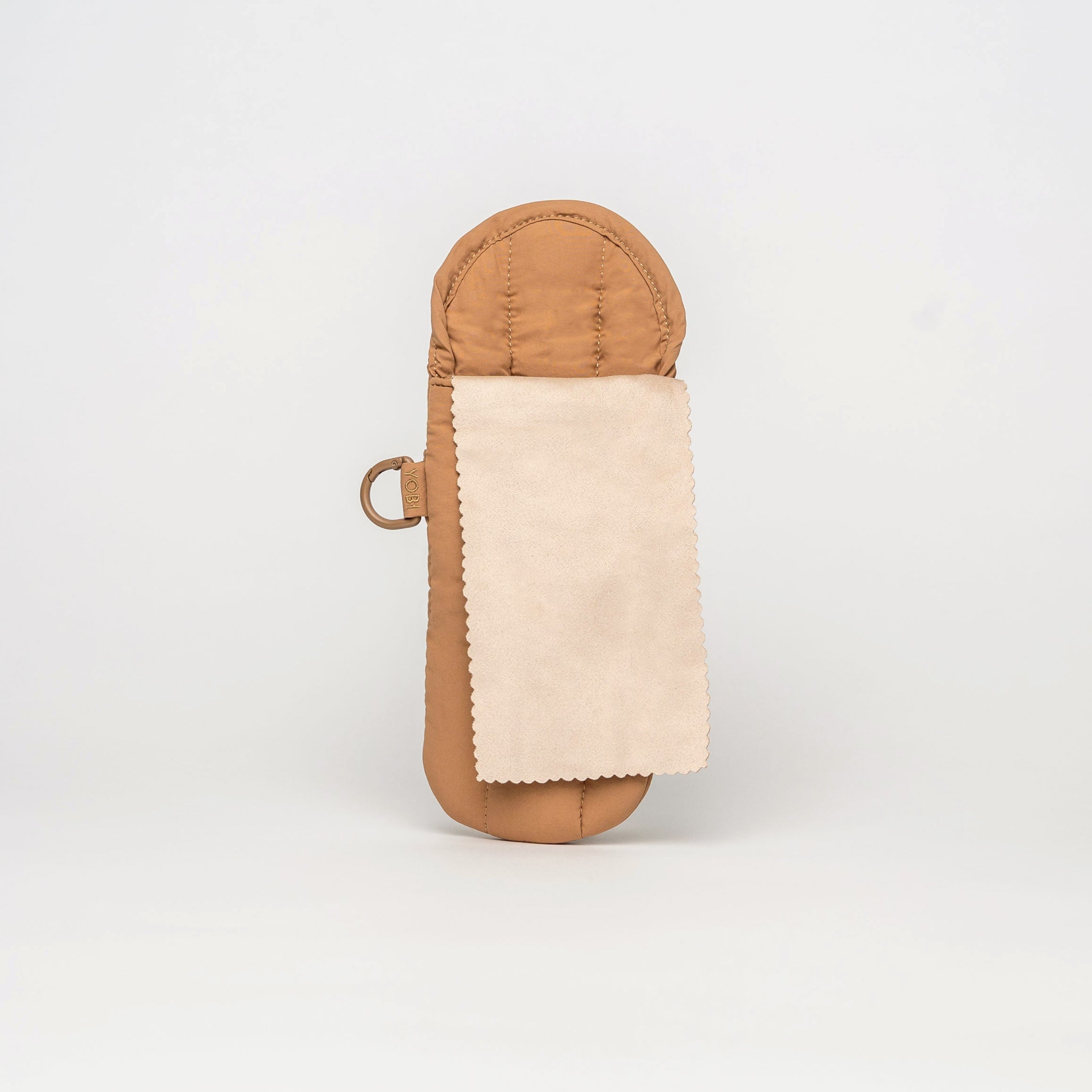 A tan leather pouch with a light beige suede flap, shown against a plain white studio background.