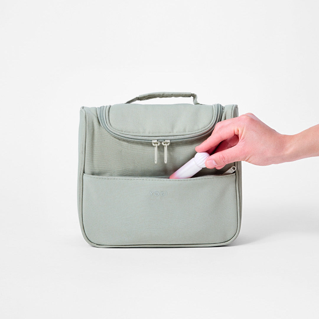 Travel toiletry bag with 11 pockets, hanging hook and toothbrush loop for easy organisation